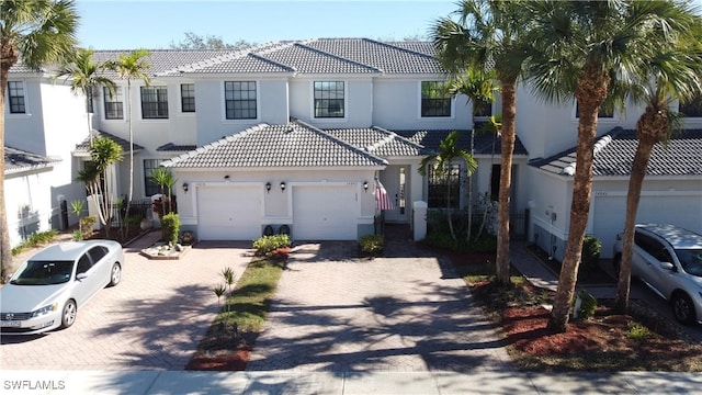 mediterranean / spanish-style home with a garage