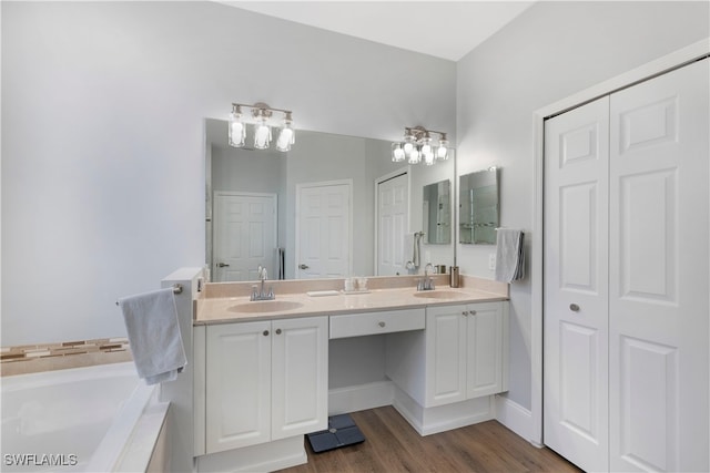 bathroom with vanity, a tub to relax in, and hardwood / wood-style flooring