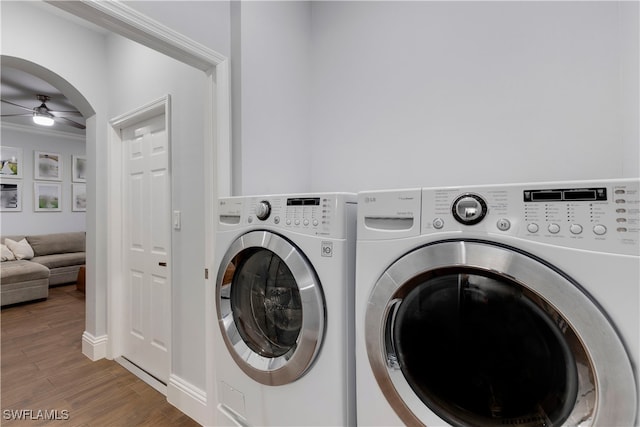 laundry room featuring wood-type flooring, separate washer and dryer, and ceiling fan