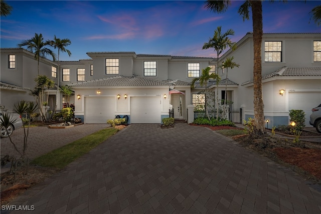 mediterranean / spanish home featuring a garage