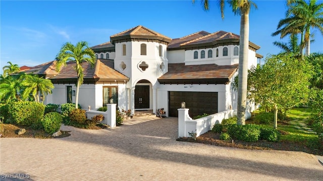 mediterranean / spanish-style house with a garage