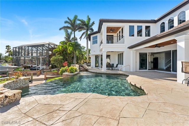 view of pool with ceiling fan and a patio area