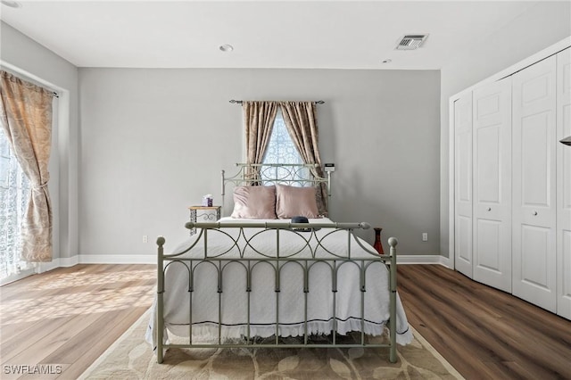 bedroom with hardwood / wood-style floors and a closet