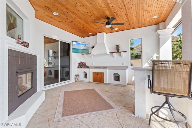 view of patio with ceiling fan and area for grilling