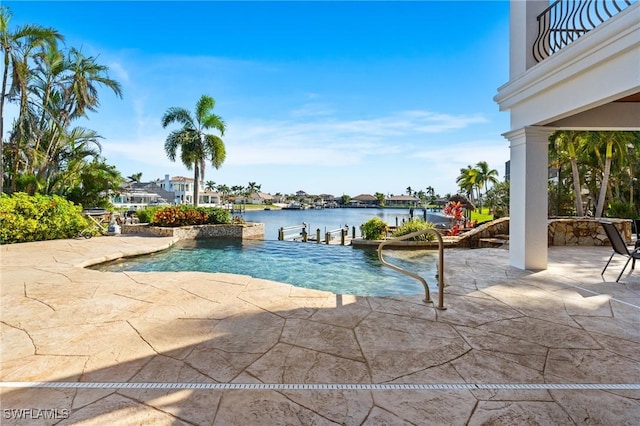 view of swimming pool featuring a patio area and a water view