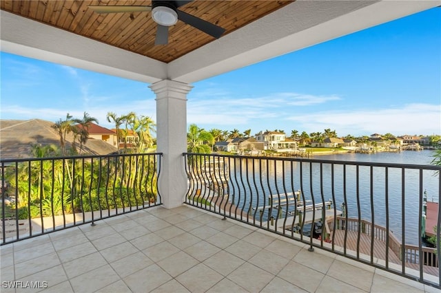 balcony featuring a water view and ceiling fan