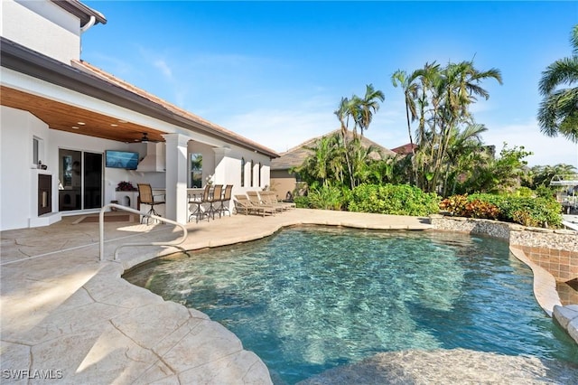 view of swimming pool with a patio and ceiling fan