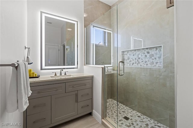 bathroom with vanity and a shower with shower door