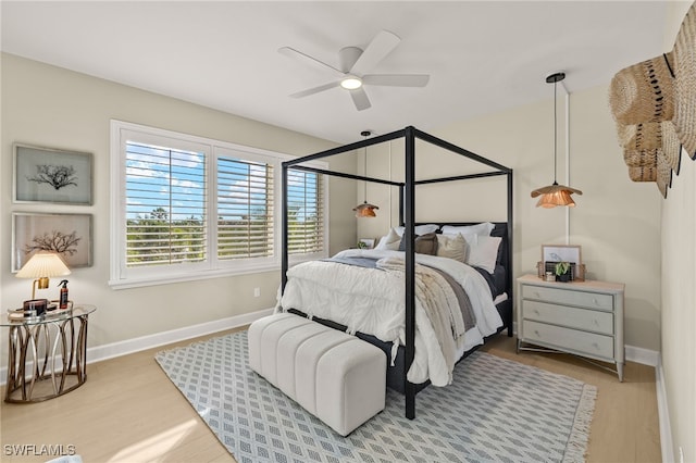 bedroom with wood-type flooring and ceiling fan