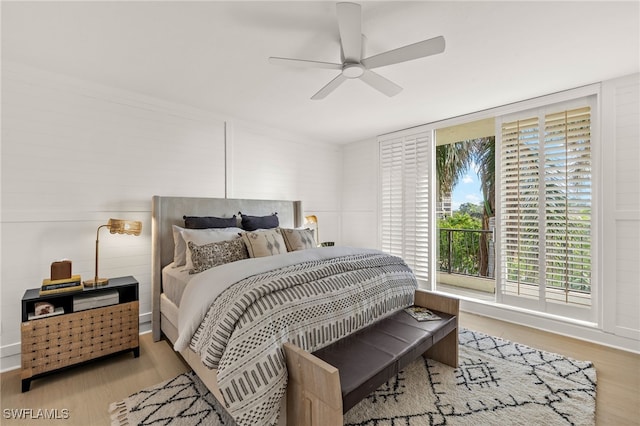 bedroom with light hardwood / wood-style flooring and ceiling fan