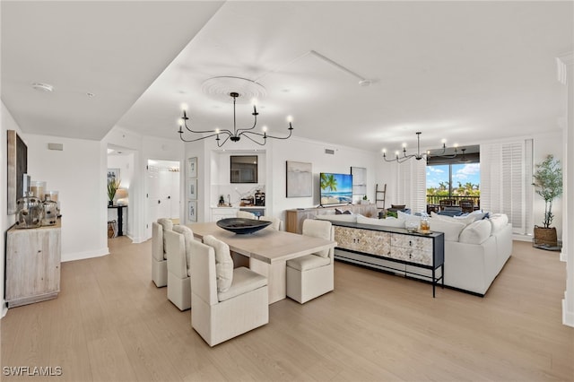 dining room with an inviting chandelier and light hardwood / wood-style flooring