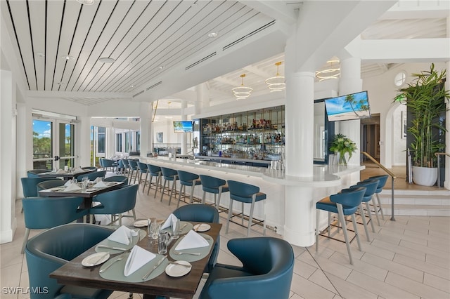 interior space with light tile patterned flooring and wood ceiling