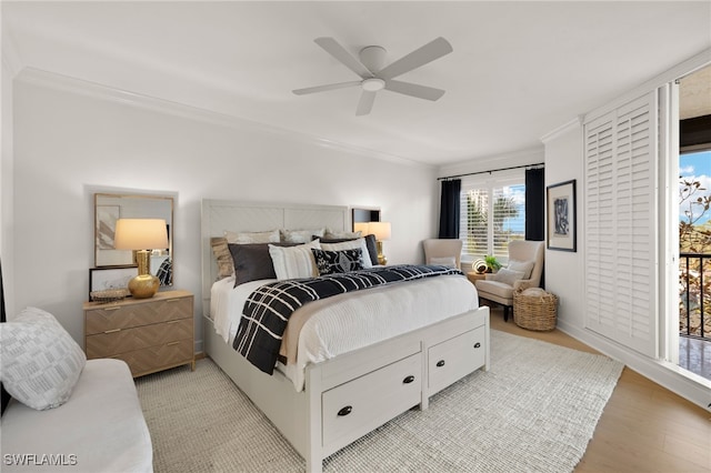 bedroom with ceiling fan, light wood-type flooring, and crown molding