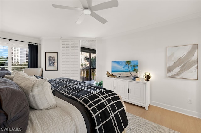 bedroom with light hardwood / wood-style flooring, ceiling fan, and crown molding