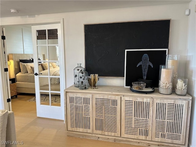 interior details with french doors and wood-type flooring