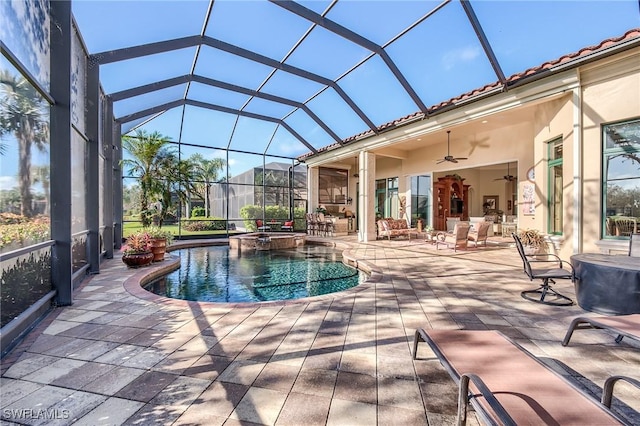 view of swimming pool with an in ground hot tub, glass enclosure, ceiling fan, and a patio area