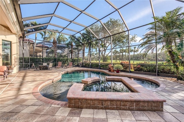 view of pool with an in ground hot tub, a patio, and glass enclosure