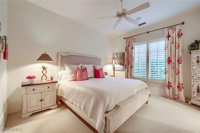 bedroom with ceiling fan and light carpet