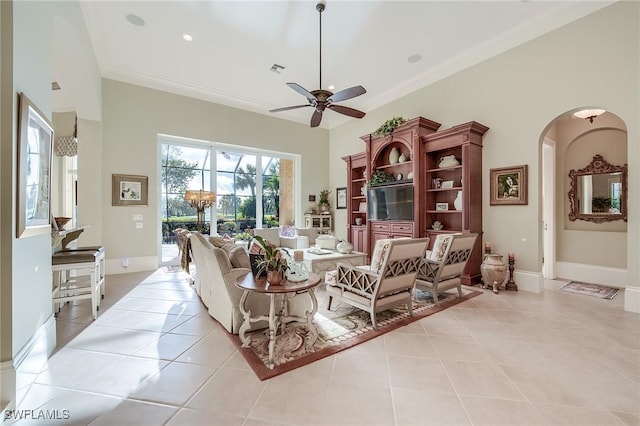 tiled living room featuring ceiling fan and ornamental molding