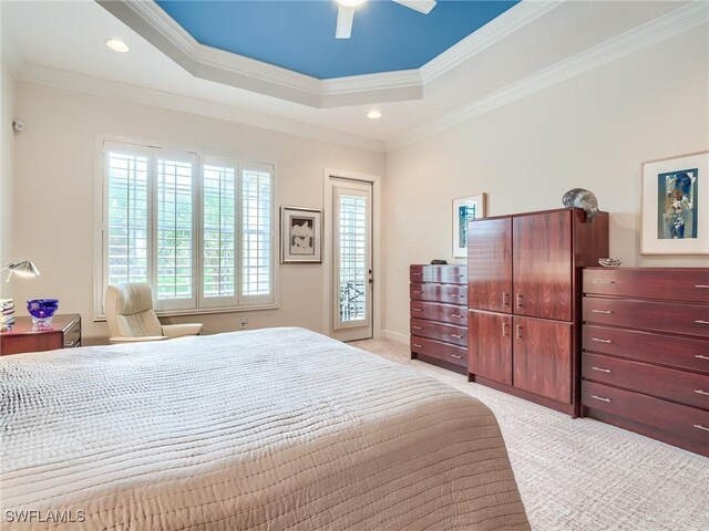 bedroom featuring ceiling fan, ornamental molding, a raised ceiling, and multiple windows