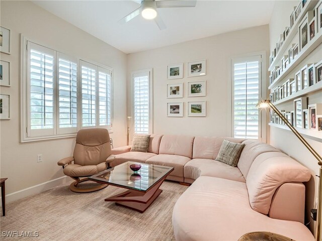 carpeted living room with ceiling fan