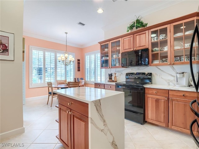 kitchen featuring an inviting chandelier, light tile patterned floors, crown molding, and black appliances