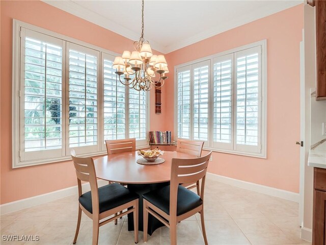 dining area with light tile patterned floors, an inviting chandelier, and crown molding