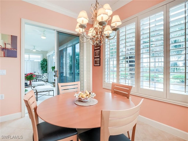 tiled dining space with ceiling fan with notable chandelier and ornamental molding