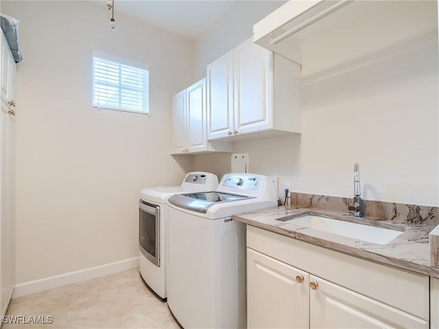 clothes washing area featuring cabinets, separate washer and dryer, sink, and light tile patterned floors