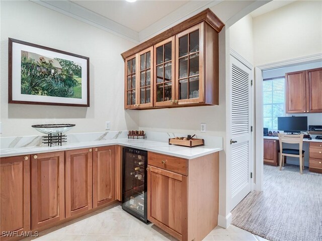 bar featuring light tile patterned floors, beverage cooler, and crown molding