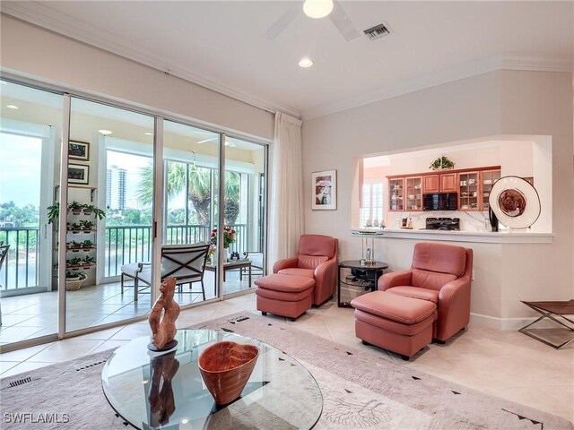 tiled living room featuring ceiling fan and crown molding