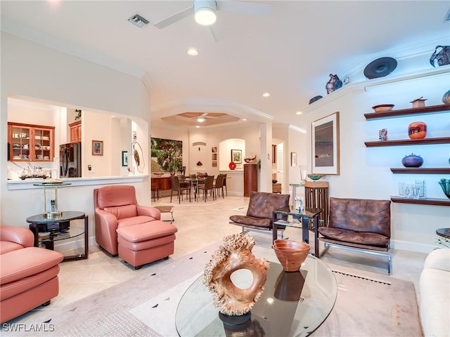 living room featuring crown molding, ceiling fan, and light tile patterned flooring