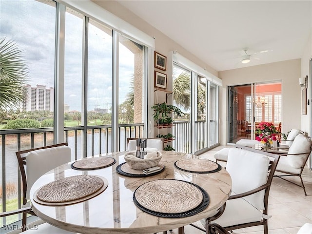 sunroom featuring ceiling fan and plenty of natural light