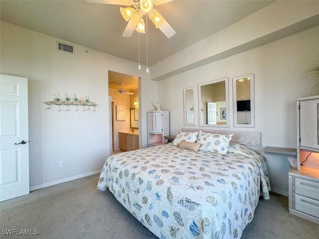 carpeted bedroom with ensuite bathroom and ceiling fan