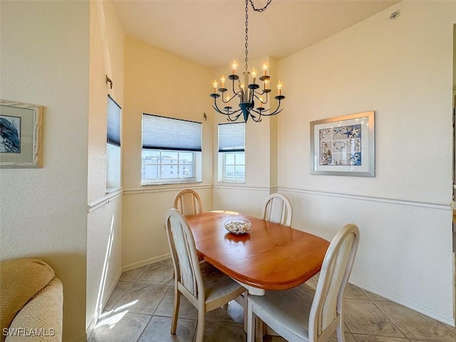 tiled dining area featuring a chandelier