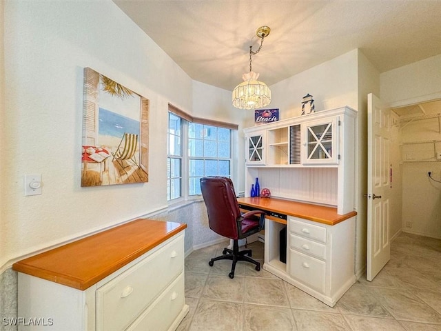 tiled home office with a notable chandelier