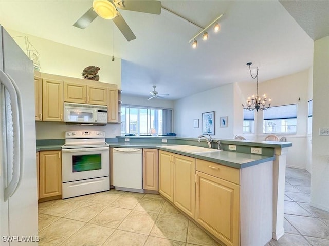 kitchen with kitchen peninsula, sink, light tile patterned floors, and white appliances