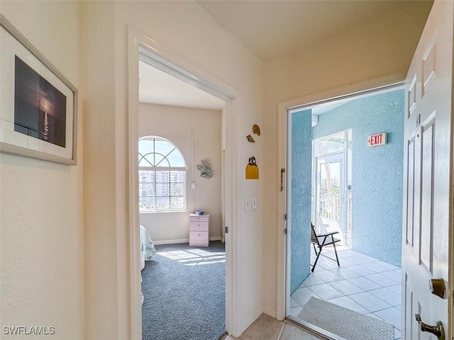 hallway featuring light colored carpet