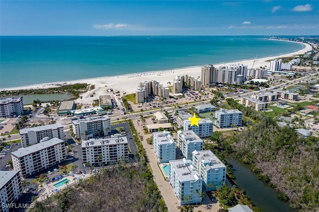 drone / aerial view featuring a water view and a beach view