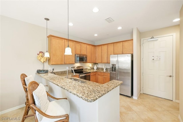 9067 Capistrano St N Unit 4502, Naples, FL 34113 - kitchen with kitchen peninsula, appliances with stainless steel finishes, light stone counters, light tile patterned floors, and pendant lighting