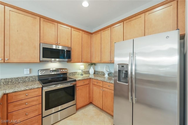 9067 Capistrano St N Unit 4502, Naples, FL 34113 - kitchen with light stone countertops, appliances with stainless steel finishes, and light tile patterned floors