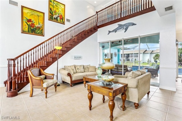 tiled living room featuring a high ceiling