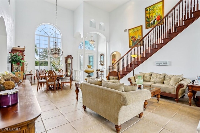 tiled living room featuring a high ceiling and a notable chandelier