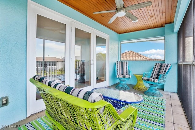 sunroom with ceiling fan and wood ceiling