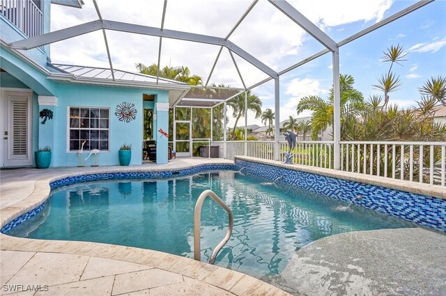 view of pool featuring a lanai, a patio area, and pool water feature