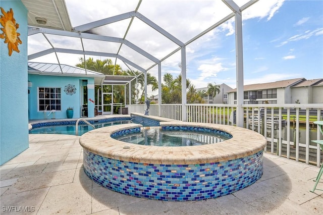 view of pool featuring a lanai, a water view, an in ground hot tub, and a patio