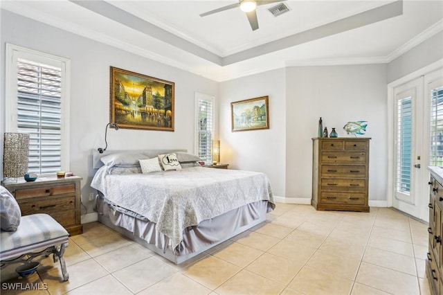 bedroom featuring ceiling fan, a tray ceiling, crown molding, light tile patterned flooring, and access to exterior