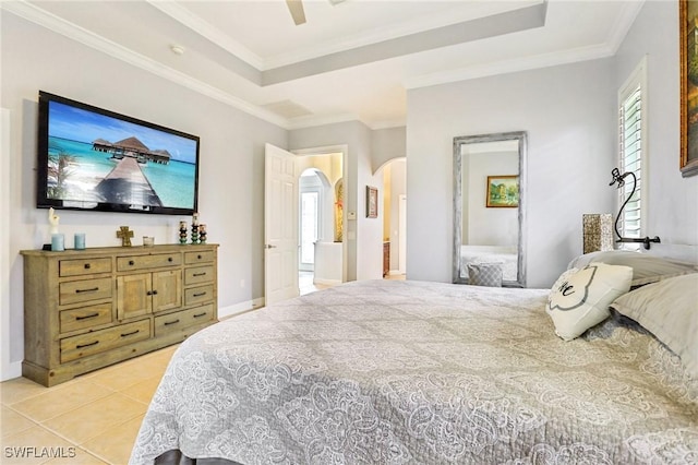 tiled bedroom featuring crown molding, ceiling fan, and a tray ceiling