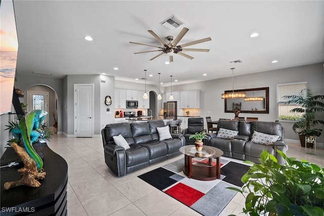 tiled living room with ceiling fan