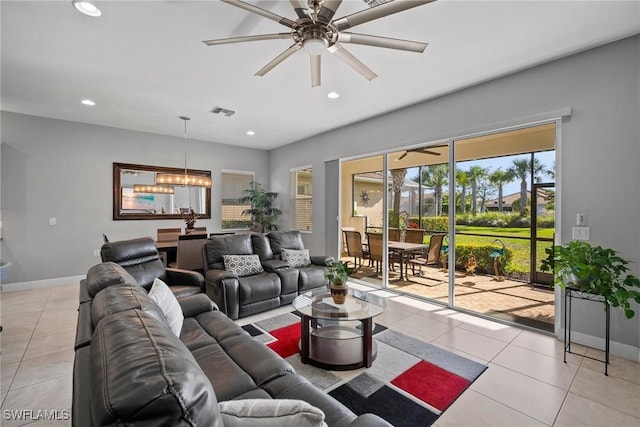 tiled living room featuring ceiling fan with notable chandelier